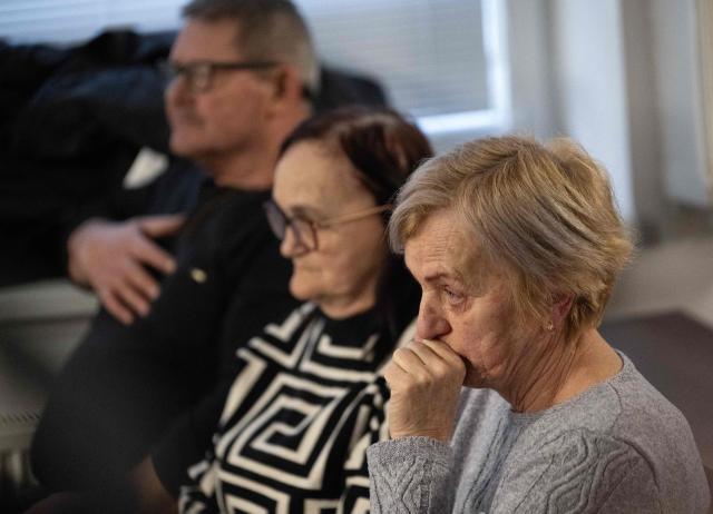 Zlatica Kusnirova (front) mother of Martina Kusnirova, and the parents of Jan Kuciak Jana Kuciakova (C) and Jozef Kuciak (back) attend the retrial of Slovak businessman Marian Kocner (unseen), accused of ordering the killing of journalist Jan Kuciak and his fiancee Martina Kusnirova, is guarded by armed police as he attends a retrial at Slovak Specialized court in Pezinok, Slovakia, on January 26, 2026. Jan Kuciak, a journalist investigating high-level corruption linked to influential businessmen and top politicians, was shot dead with his fiancee, Martina Kusnirova, both 27, at their home in the village of Velka Maca in February 2018. Their deaths sparked the largest protests in Slovakia since the fall of Communism, leading to the resignation of the government of Robert Fico, although the nationalist prime minister returned to power in 2023. (Photo by Joe Klamar / AFP)