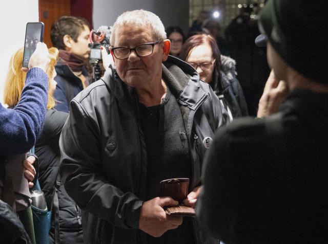The parents of Jan Kuciak, Jozef Kuciak and Jana Kuciakova (back) arrive for the retrial of Slovak businessman Marian Kocner (unseen), accused of ordering the killing of journalist Jan Kuciak and his fiancee Martina Kusnirova, is guarded by armed police as he attends a retrial at Slovak Specialized court in Pezinok, Slovakia, on January 26, 2026. Jan Kuciak, a journalist investigating high-level corruption linked to influential businessmen and top politicians, was shot dead with his fiancee, Martina Kusnirova, both 27, at their home in the village of Velka Maca in February 2018. Their deaths sparked the largest protests in Slovakia since the fall of Communism, leading to the resignation of the government of Robert Fico, although the nationalist prime minister returned to power in 2023. (Photo by Joe Klamar / AFP)
