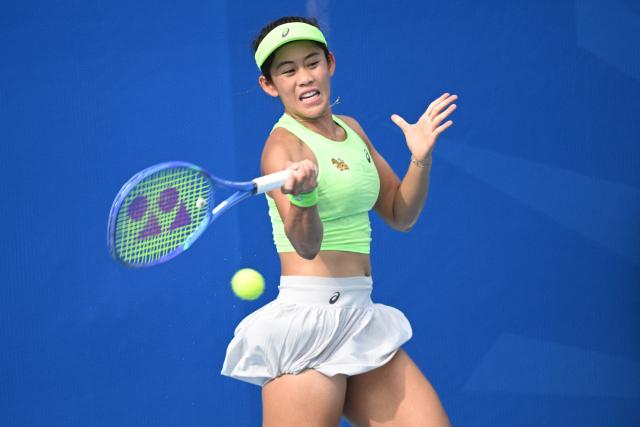 Lanlana Tararudee of Thailand hits a return against Simona Waltert of Switzerland during their women's singles match at the Philippine Women's Open tennis tournament in Manila on January 26, 2026. (Photo by Ted ALJIBE / AFP)
