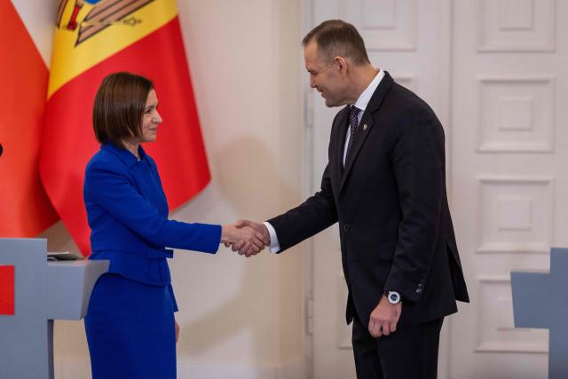 Poland's President Karol Nawrocki (R) and Moldova's President Maia Sandu (L) shake hands after a joint press conference at the Presidential Palace in Warsaw, Poland, on January 26, 2026. (Photo by Wojtek RADWANSKI / AFP)