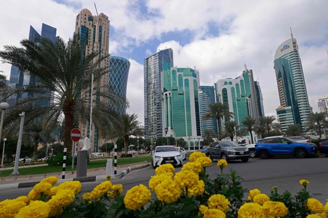 Cars drive along the Corniche area on a cloudy day in Doha on January 26, 2026. (Photo by Karim JAAFAR / AFP)