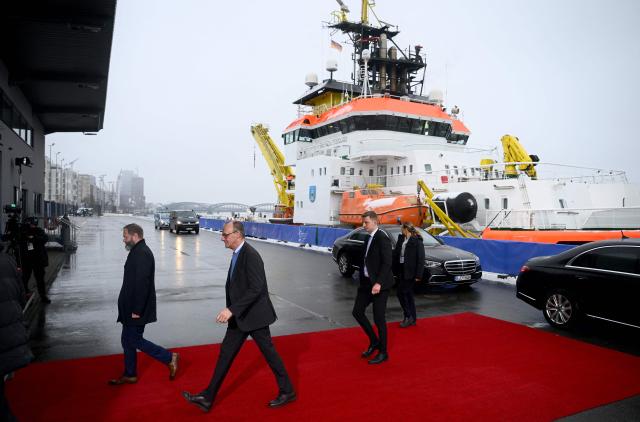 German Chancellor Friedrich Merz (2nd L) arrives to attend the North Sea Summit on January 26, 2026 in Hamburg, northern Germany. European leaders meet to discuss North Sea energy and security cooperation, but fears over US designs on the Arctic island of Greenland may overshadow the talks. The region has long worried about threats posed by Russia -- but more recently tensions have surged over US President Donald Trump's push for the autonomous territory of Denmark. (Photo by Gregor Fischer / AFP)