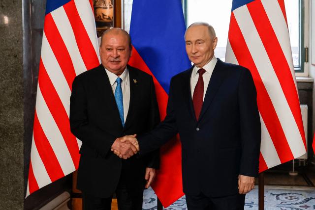 Russian President Vladimir Putin welcomes Malaysia's King Sultan Ibrahim during their meeting at the State Hermitage Museum in Saint Petersburg on January 26, 2026. (Photo by ANATOLY MALTSEV / POOL / AFP)