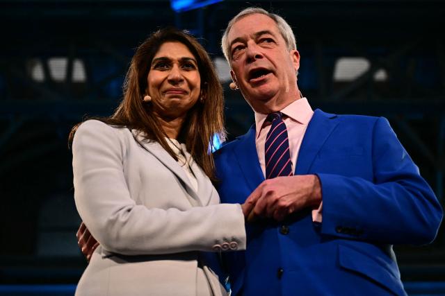 Reform UK leader Nigel Farage stands on stage with Britain's former Conservative party MP and former Home Secretary Suella Braverman during a Reform UK press conference in central London on January 26, 2026, where she announced her defection to Reform. (Photo by Ben STANSALL / AFP)