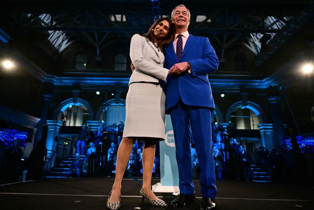 Reform UK leader Nigel Farage stands on stage with Britain's former Conservative party MP and former Home Secretary Suella Braverman during a Reform UK press conference in central London on January 26, 2026, where she announced her defection to Reform. (Photo by Ben STANSALL / AFP)