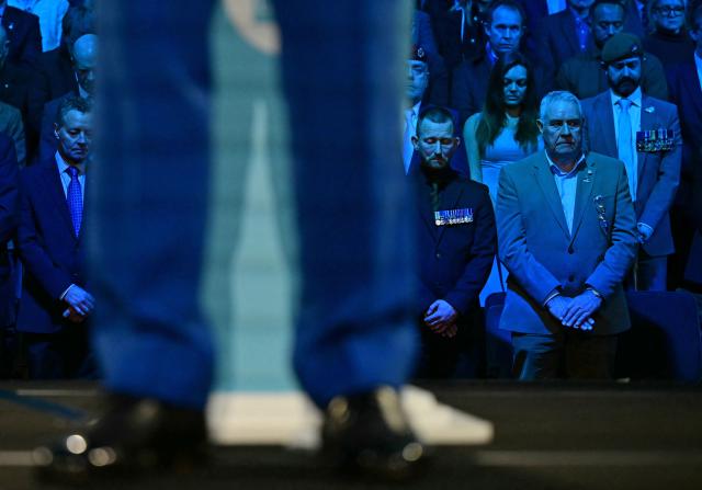 Delegates including military veterans listen to Reform UK leader Nigel Farage speak during a press conference in central London on January 26, 2026, where it was announced that Britain's former Conservative party MP, and former Home Secretary Suella Braverman had defected to the party. (Photo by Ben STANSALL / AFP)