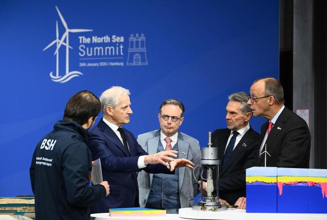 (R-L) German Chancellor Friedrich Merz, Netherland's Prime Minister Dick Schoof, Belgium's Prime Minister Bart de Wever and Norway's Prime Minister Jonas Gahr Store talk as they attend the North Sea Summit on January 26, 2026 in Hamburg, northern Germany. European leaders meet to discuss North Sea energy and security cooperation, but fears over US designs on the Arctic island of Greenland may overshadow the talks. The region has long worried about threats posed by Russia -- but more recently tensions have surged over US President Donald Trump's push for the autonomous territory of Denmark. (Photo by Gregor Fischer / AFP)