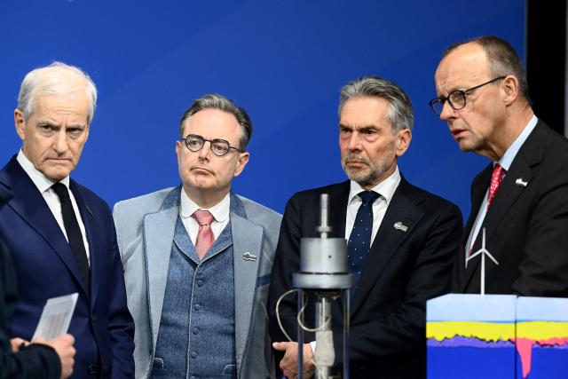 (R-L) German Chancellor Friedrich Merz, Netherland's Prime Minister Dick Schoof, Belgium's Prime Minister Bart de Wever and Norway's Prime Minister Jonas Gahr Store listen to explanations they get from a staff member of the Federal Maritime and Hydrographic Agency (BSH) as they attend the North Sea Summit on January 26, 2026 in Hamburg, northern Germany. European leaders meet to discuss North Sea energy and security cooperation, but fears over US designs on the Arctic island of Greenland may overshadow the talks. The region has long worried about threats posed by Russia -- but more recently tensions have surged over US President Donald Trump's push for the autonomous territory of Denmark. (Photo by Gregor Fischer / AFP)