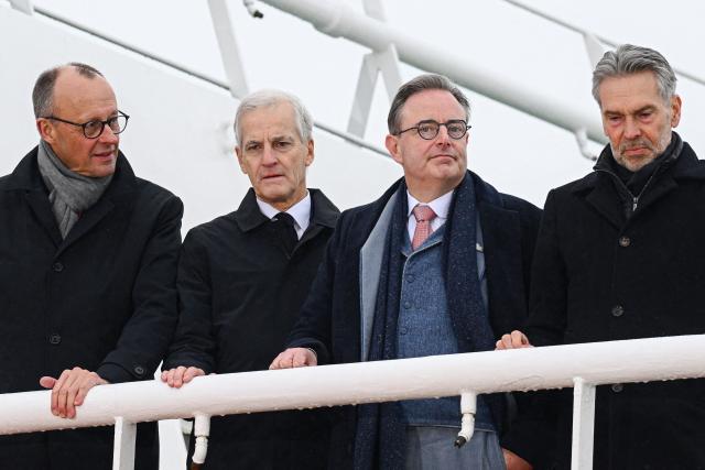 (L-R) German Chancellor Friedrich Merz, Norway's Prime Minister Jonas Gahr Store, Belgium's Prime Minister Bart de Wever and Netherland's Prime Minister Dick Schoof are seen onboard the "Neuwerk" coast guard ship during the North Sea Summit on January 26, 2026 in Hamburg, northern Germany. European leaders meet to discuss North Sea energy and security cooperation, but fears over US designs on the Arctic island of Greenland may overshadow the talks. The region has long worried about threats posed by Russia -- but more recently tensions have surged over US President Donald Trump's push for the autonomous territory of Denmark. (Photo by Gregor Fischer / AFP)