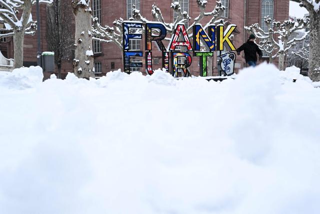 A man walks on the snow-covered square in front of St Paul's Church in Frankfurt am Main, western Germany, on January 26, 2026 as the air temperature reached 1 degrees Celsius above zero. (Photo by Kirill KUDRYAVTSEV / AFP)