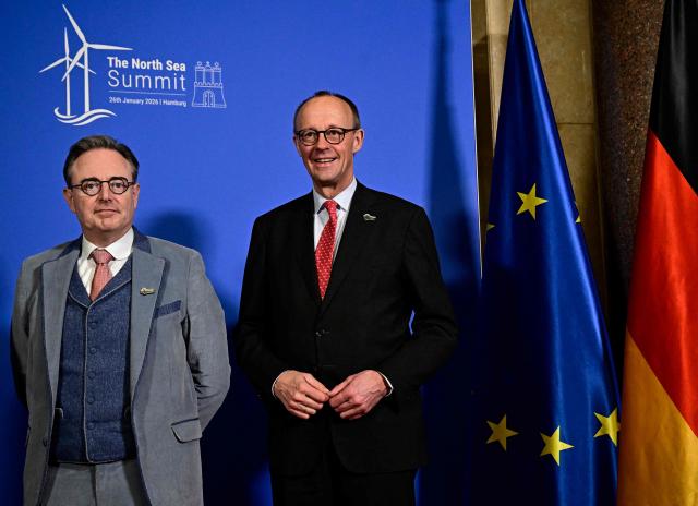 Belgium's Prime Minister Bart de Wever (L) and German Chancellor Friedrich Merz pose for a picture prior to a meeting at Hamburg's city hall during the North Sea Summit on January 26, 2026 in Hamburg, northern Germany. European leaders meet to discuss North Sea energy and security cooperation, but fears over US designs on the Arctic island of Greenland may overshadow the talks. The region has long worried about threats posed by Russia -- but more recently tensions have surged over US President Donald Trump's push for the autonomous territory of Denmark. (Photo by Tobias SCHWARZ / AFP)