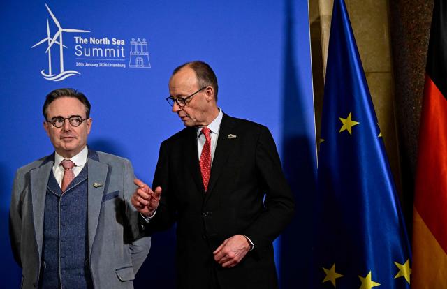Belgium's Prime Minister Bart de Wever (L) and German Chancellor Friedrich Merz pose for a picture prior to a meeting at Hamburg's city hall during the North Sea Summit on January 26, 2026 in Hamburg, northern Germany. European leaders meet to discuss North Sea energy and security cooperation, but fears over US designs on the Arctic island of Greenland may overshadow the talks. The region has long worried about threats posed by Russia -- but more recently tensions have surged over US President Donald Trump's push for the autonomous territory of Denmark. (Photo by Tobias SCHWARZ / AFP)