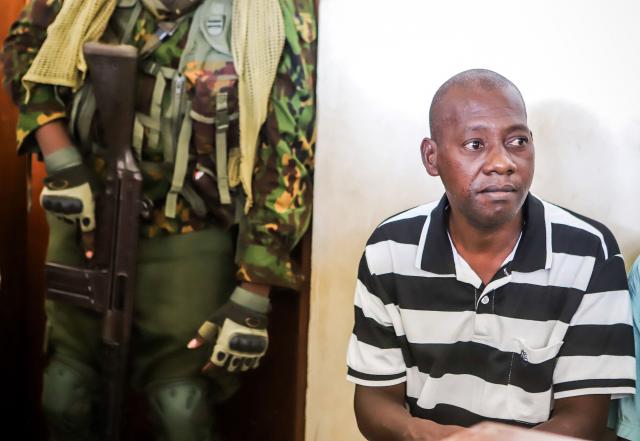 (FILES) Self-proclaimed pastor Paul Nthenge Mackenzie looks on as he appears at Malindi Law Courts in Malindi on February 6, 2024. Self-proclaimed preacher Paul Nthenge Mackenzie, linked to an infamous starvation cult that killed more than 400 people, will be charged over an additional 52 deaths at another village, prosecutors said on January 26, 2026. (Photo by AFP)