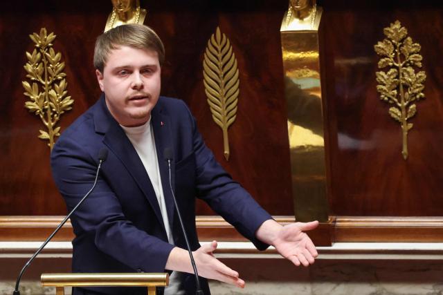 La France Insoumise - Nouveau Front Populaire's MP Louis Boyard gestures as he delivers remarks during a parliamentary debate on legislative process for a social media ban on under-15s at the Assemblee Nationale, France's lower house Parliament in Paris on January 26, 2026. French lawmakers are set to vote on draft legislation to ban social media for under-15s, an effort championed by President Emmanuel Macron as a way to protect children from excessive screen time. The legislation, which also provides for a ban on mobile phones in high schools, follows Australia banning social media for under-16s in December, a world first. As social media has grown around the world, so has concern that too much screen time is arresting child development and contributing to declining mental health in minors. (Photo by Ludovic MARIN / AFP)