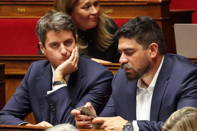 President of Ensemble Pour la Republique parliamentary group Gabriel Attal (L) and Ensemble Pour la Republique's MP Guillaume Kasbarian attend a parliamentary debate on legislative process for a social media ban on under-15s at the Assemblee Nationale, France's lower house Parliament in Paris on January 26, 2026. French lawmakers are set to vote on draft legislation to ban social media for under-15s, an effort championed by President Emmanuel Macron as a way to protect children from excessive screen time. The legislation, which also provides for a ban on mobile phones in high schools, follows Australia banning social media for under-16s in December, a world first. As social media has grown around the world, so has concern that too much screen time is arresting child development and contributing to declining mental health in minors. (Photo by Ludovic MARIN / AFP)