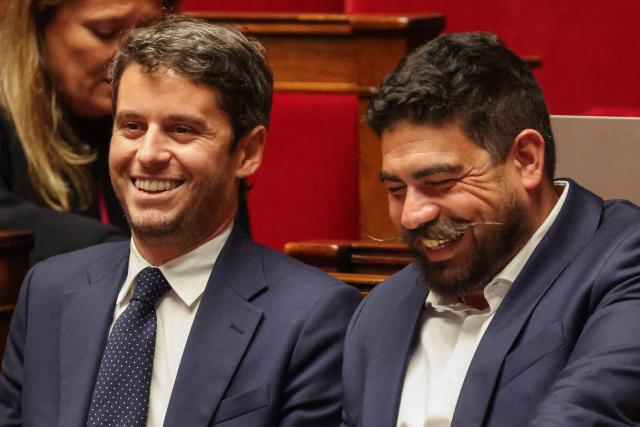 President of Ensemble Pour la Republique parliamentary group Gabriel Attal (L) and Ensemble Pour la Republique's MP Guillaume Kasbarian attend a parliamentary debate on legislative process for a social media ban on under-15s at the Assemblee Nationale, France's lower house Parliament in Paris on January 26, 2026. French lawmakers are set to vote on draft legislation to ban social media for under-15s, an effort championed by President Emmanuel Macron as a way to protect children from excessive screen time. The legislation, which also provides for a ban on mobile phones in high schools, follows Australia banning social media for under-16s in December, a world first. As social media has grown around the world, so has concern that too much screen time is arresting child development and contributing to declining mental health in minors. (Photo by Ludovic MARIN / AFP)
