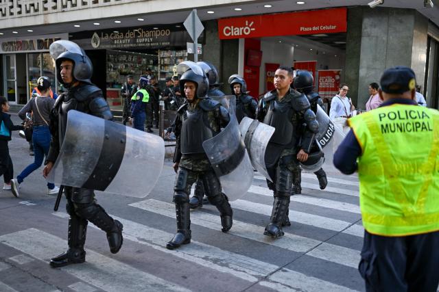 Members of the Honduran military police patrol the historic center of Tegucigalpa on January 26, 2026, ahead of the inauguration of President-elect Nasry Asfura. (Photo by JOHAN ORDONEZ / AFP)