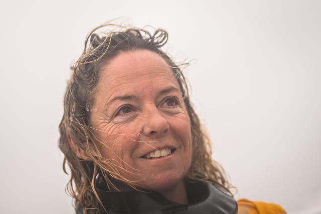 French skipper Alexia Barrier reacts as she and her crew sail towards the Brest harbour on the Ultim multihull Idec Sport after crossing the finish line of the Jules Verne Trophy, off the coast of Brest, Brittany, on January 26, 2026. French skipper Alexia Barrier (The Famous Project) and her six crew members completed on January 26, 2026, off the coast of Brest, the first non-stop round-the-world voyage in a maxi-trimaran with an all-female crew, her team announced. The Jules Verne Trophy is a prize for the fastest crewed, unassisted and non-stop circumnavigation of the world on any type of yacht. (Photo by Loic VENANCE / AFP)
