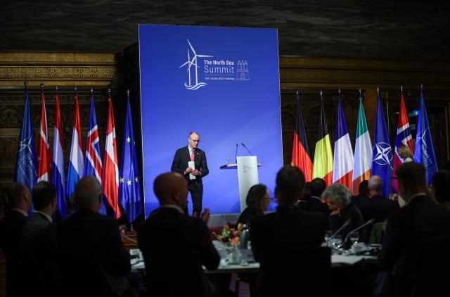 German Chancellor Friedrich Merz leaves after delivering his speech during the North Sea Summit on January 26, 2026 at the City Hall of Hamburg, northern Germany. European leaders meet to discuss North Sea energy and security cooperation, but fears over US designs on the Arctic island of Greenland may overshadow the talks. The region has long worried about threats posed by Russia -- but more recently tensions have surged over US President Donald Trump's push for the autonomous territory of Denmark. (Photo by Ronny HARTMANN / AFP)