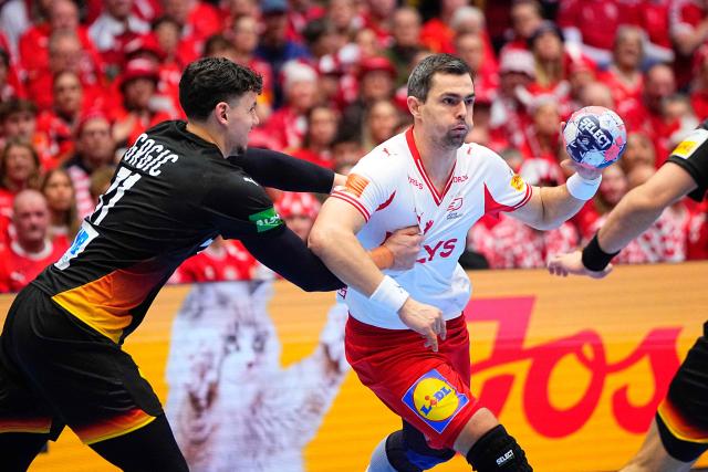 Germany's left back #71 Marko Grgic and Denmark's centre back #11 Rasmus Lauge vie for the ball during the men's EHF Euro 2026 main round handball match Germany vs Denmark in Herning, Denmark, on January 26, 2026. (Photo by Bo Amstrup / Ritzau Scanpix / AFP) / Denmark OUT