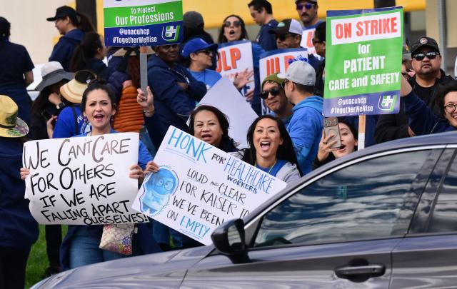 Nurses and healthcare professionals demonstrate during a strike against Kaiser Permanente outside one of their medical facilities in Los Angeles, California, on January 26, 2026. More than 31,000 registered nurses and healthcare professionals represented by the United Nurses Associations of California and the Union of Health Care Professionals began a strike against Kaiser Permanente in California and Hawaii, pushing for increased staffing levels and wage boosts. (Photo by Frederic J. BROWN / AFP)