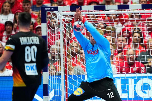 Denmark's goalkeeper #12 Emil Nielsen makes a save in front of Germany's pivot #80 Jannik Kohlbacher during the men's EHF Euro 2026 main round handball match Germany vs Denmark in Herning, Denmark, on January 26, 2026. (Photo by Bo Amstrup / Ritzau Scanpix / AFP) / Denmark OUT