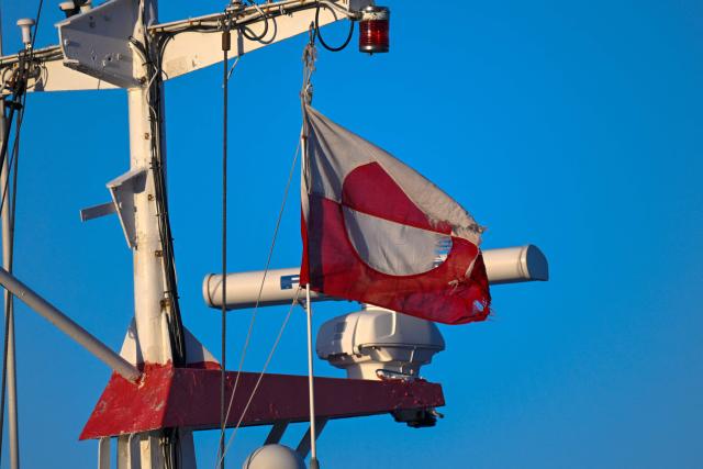 A photo shows the flag of Greenland at a ship on the harbor of Nuuk, Greenland, on January 26, 2026. (Photo by Ina FASSBENDER / AFP)