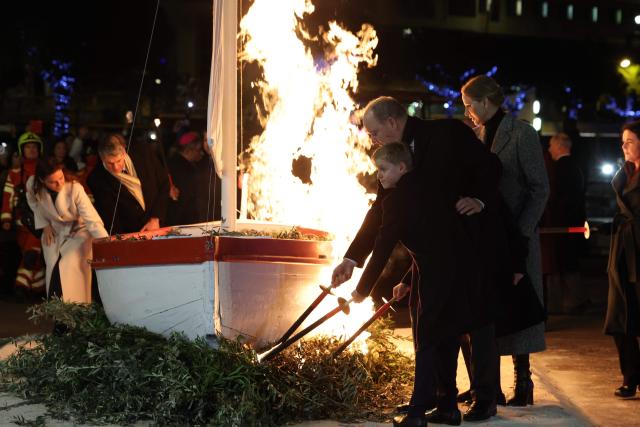 Prince Albert II of Monaco (C), Princess Charlene (R) and their children Prince Jacques (L) and Princess Gabriella, use torches to light tree branches displayed underneath a sailbot during the traditional celebration of Sainte-Devote in the Principality of Monaco on January 26, 2026. (Photo by Valery HACHE / AFP) / / NO TABLOIDS WEB & PRINT, NO DAILY MAIL, NO DAILY MAIL GROUP, NO VOICI, NO CLOSER