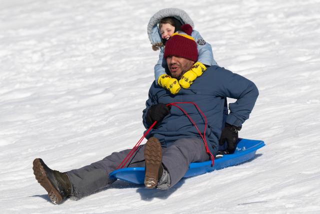 People go sledding outside the US Capitol in Washington, DC, on January 26, 2026, following a significant snow storm. Millions of Americans were facing dangerously cold temperatures in the wake of a massive winter storm that whipped snow and ice across the country, knocking out power and paralyzing transportation. A frigid, potentially life-threatening Arctic air mass threatened to delay clean-up as municipalities from New Mexico to Maine tried to dig out following the storm, which dropped a vicious cocktail of heavy snow and wind along with freezing rain and sleet. (Photo by SAUL LOEB / AFP)