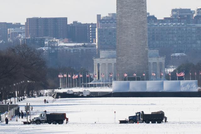 Snowplows drive near the Washington Monument and Lincoln Memorial on the National Mall in Washington, DC, on January 26, 2026, following a significant snow storm. Millions of Americans were facing dangerously cold temperatures in the wake of a massive winter storm that whipped snow and ice across the country, knocking out power and paralyzing transportation. A frigid, potentially life-threatening Arctic air mass threatened to delay clean-up as municipalities from New Mexico to Maine tried to dig out following the storm, which dropped a vicious cocktail of heavy snow and wind along with freezing rain and sleet. (Photo by SAUL LOEB / AFP)