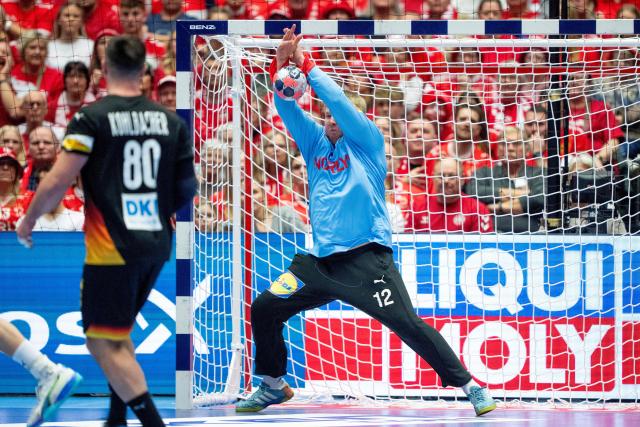 Denmark's goalkeeper #12 Emil Nielsen stretches to save the ball during the men's EHF Euro 2026 main round handball match between Germany and Denmark at the at Jyske Bank Boxen Arena in Herning, Denmark, on January 26, 2026. (Photo by Bo Amstrup / Ritzau Scanpix / AFP) / Denmark OUT