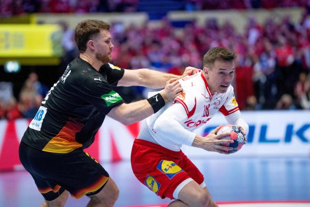Denmark's left back #28 Lasse Andersson (R) and Germany's pivot #04 Johannes Golla (L) compete for the ball during the men's EHF Euro 2026 main round handball match between Germany and Denmark at the at Jyske Bank Boxen Arena in Herning, Denmark, on January 26, 2026. (Photo by Bo Amstrup / Ritzau Scanpix / AFP) / Denmark OUT