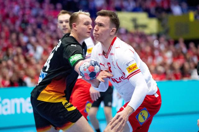 Denmark's left back #28 Lasse Andersson (R) and Germany's pivot #54 Justus Fischer (L) compete for the ball during the men's EHF Euro 2026 main round handball match between Germany and Denmark at the at Jyske Bank Boxen Arena in Herning, Denmark, on January 26, 2026. (Photo by Bo Amstrup / Ritzau Scanpix / AFP) / Denmark OUT