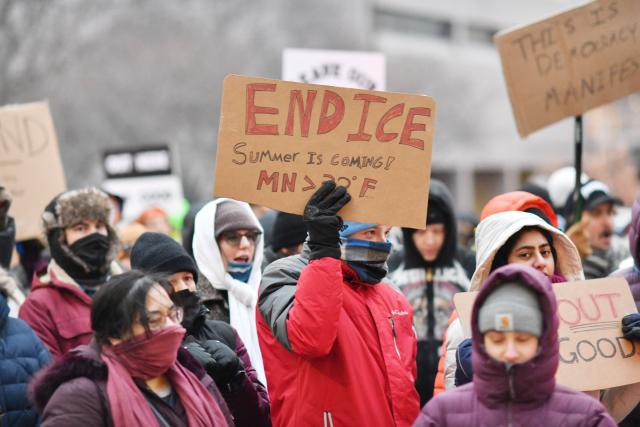Demonstrators against US Immigration and Customs Enforcement (ICE) protest outside the state office of US Senator Amy Klobuchar, Democrat of Minnesota, following last week fatal shooting of 37-year-old ICU nurse Alex Pretti by ICE agents during a federal immigration enforcement operation in Minneapolis, Minnesota, on January 26, 2026. On January 24, federal agents shot and killed Alex Pretti, a 37-year-old ICU nurse, while scuffling with him on an icy roadway in Minneapolis, less than three weeks after an immigration officer fired on Renee Good, also 37, killing her in her car. US President Donald Trump blamed their deaths on Democratic "chaos," as his administration faced intensifying pressure over its mass immigration crackdown in Minneapolis. (Photo by Octavio JONES / AFP)