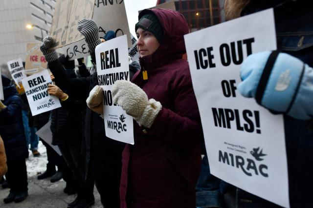 Demonstrators against US Immigration and Customs Enforcement (ICE) protest outside the state office of US Senator Amy Klobuchar, Democrat of Minnesota, following last week fatal shooting of 37-year-old ICU nurse Alex Pretti by ICE agents during a federal immigration enforcement operation in Minneapolis, Minnesota, on January 26, 2026. On January 24, federal agents shot and killed Alex Pretti, a 37-year-old ICU nurse, while scuffling with him on an icy roadway in Minneapolis, less than three weeks after an immigration officer fired on Renee Good, also 37, killing her in her car. US President Donald Trump blamed their deaths on Democratic "chaos," as his administration faced intensifying pressure over its mass immigration crackdown in Minneapolis. (Photo by Octavio JONES / AFP)