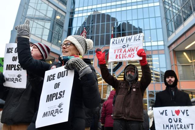 Demonstrators against US Immigration and Customs Enforcement (ICE) protest outside the state office of US Senator Amy Klobuchar, Democrat of Minnesota, following last week fatal shooting of 37-year-old ICU nurse Alex Pretti by ICE agents during a federal immigration enforcement operation in Minneapolis, Minnesota, on January 26, 2026. On January 24, federal agents shot and killed Alex Pretti, a 37-year-old ICU nurse, while scuffling with him on an icy roadway in Minneapolis, less than three weeks after an immigration officer fired on Renee Good, also 37, killing her in her car. US President Donald Trump blamed their deaths on Democratic "chaos," as his administration faced intensifying pressure over its mass immigration crackdown in Minneapolis. (Photo by Octavio JONES / AFP)