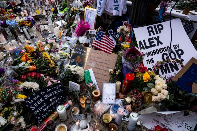 Flowers and people's messages are seen at the makeshift memorial in the area where Alex Pretti was shot and killed by federal immigration agents in Minneapolis, Minnesota, on January 26, 2026. On January 24, federal agents shot and killed Alex Pretti, a 37-year-old ICU nurse, while scuffling with him on an icy roadway in Minneapolis, less than three weeks after an immigration officer fired on Renee Good, also 37, killing her in her car. US President Donald Trump blamed their deaths on Democratic "chaos," as his administration faced intensifying pressure over its mass immigration crackdown in Minneapolis. (Photo by ROBERTO SCHMIDT / AFP)