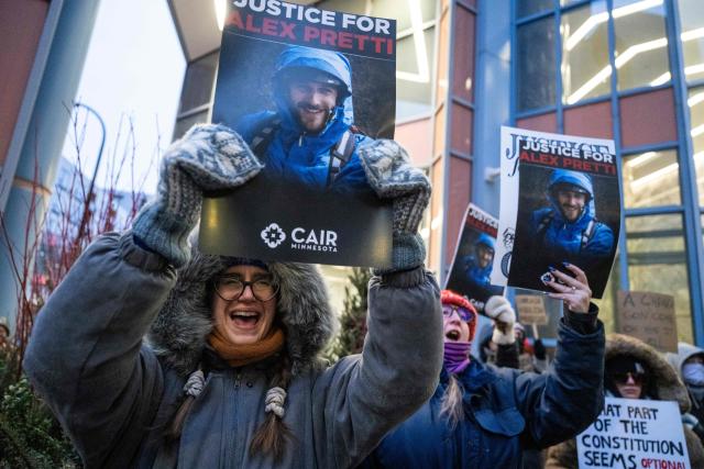 Demonstrators protest against US Immigration and Customs Enforcement (ICE) outside the state office of US Senator Amy Klobuchar, Democrat of Minnesota, following last week fatal shooting of 37-year-old ICU nurse Alex Pretti by federal immigration agents, in Minneapolis, Minnesota, on January 26, 2026. On January 24, federal agents shot and killed Alex Pretti, a 37-year-old ICU nurse, while scuffling with him on an icy roadway in Minneapolis, less than three weeks after an immigration officer fired on Renee Good, also 37, killing her in her car. US President Donald Trump blamed their deaths on Democratic "chaos," as his administration faced intensifying pressure over its mass immigration crackdown in Minneapolis. (Photo by ROBERTO SCHMIDT / AFP)