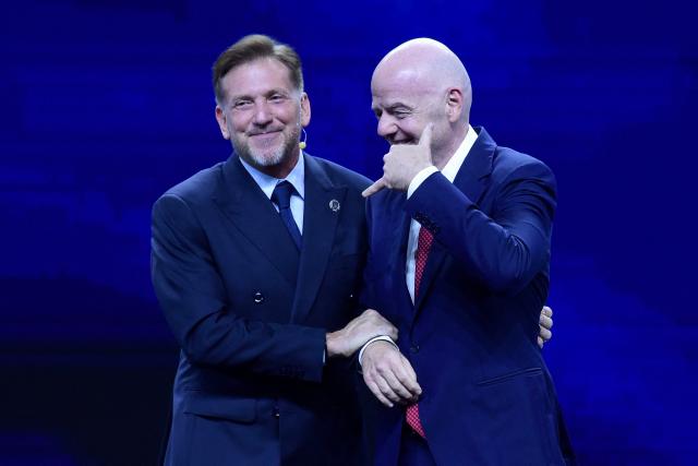 FIFA President Gianni Infantino (R) gestures next to CONMEBOL President Alejandro Dominguez (L) during a commemorative event marking the 10th anniversary of Dominguez's work as the head of the South American Football Confederation in Luque, Paraguay on January 26, 2026. (Photo by Daniel DUARTE / AFP)