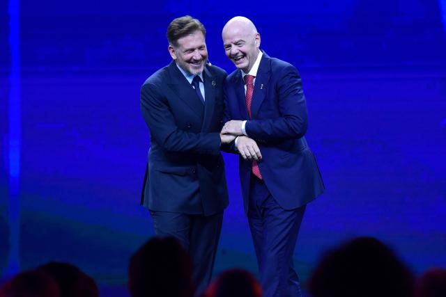 FIFA President Gianni Infantino (R) and CONMEBOL President Alejandro Dominguez (L) laugh during a commemorative event marking the 10th anniversary of Dominguez's work as the head of the South American Football Confederation in Luque, Paraguay on January 26, 2026. (Photo by Daniel DUARTE / AFP)