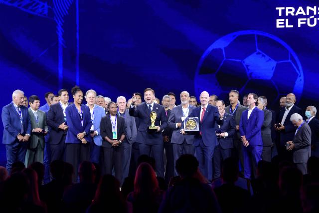 FIFA President Gianni Infantino (C-R) and CONMEBOL President Alejandro Dominguez (C-L) pose for a photo with other officials during a commemorative event marking the 10th anniversary of Dominguez's work as the head of the South American Football Confederation in Luque, Paraguay on January 26, 2026. (Photo by Daniel DUARTE / AFP)