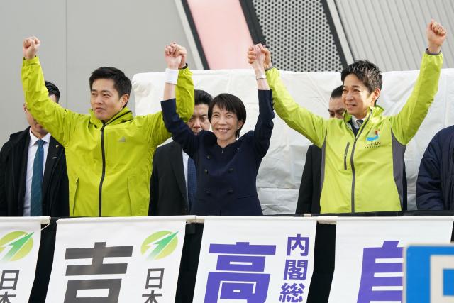 Japan's Prime Minister and President of the Liberal Democratic Party Sanae Takaichi (C) and Co-leaders of the Japan Innovation Party, Hirofumi Yoshimura (L), Fumitake Fujita (R) attend their first campaign speech for the House of Representatives election in Tokyo on January 27, 2026. (Photo by Kazuhiro NOGI / AFP)
