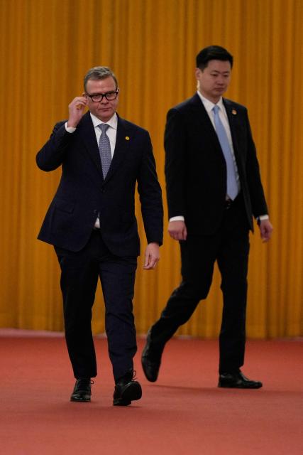 Finland's Prime Minister Petteri Orpo (L) arrives to meet with Chinese President Xi Jinping at the Great Hall of the People in Beijing on January 27, 2026. (Photo by Vincent Thian / POOL / AFP)