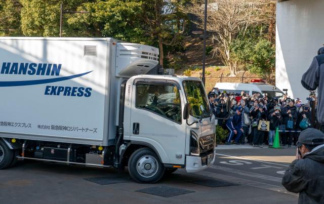 A truck believed to be carrying the twin pandas departs from Ueno Zoo in Tokyo on January 27, 2026, heading towards their return to China. (Photo by Kazuhiro NOGI / AFP)