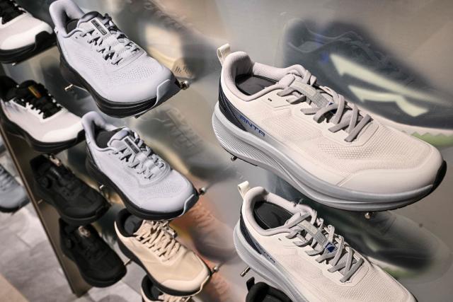 Anta shoes are seen in an Anta store in the Huangpu district of Shanghai on January 27, 2026. Chinese athletic goods giant Anta Sports will buy a controlling stake in historic German sportswear brand Puma for 1.79 billion USD, a stock exchange filing showed, as it expands its international presence. (Photo by Hector RETAMAL / AFP)