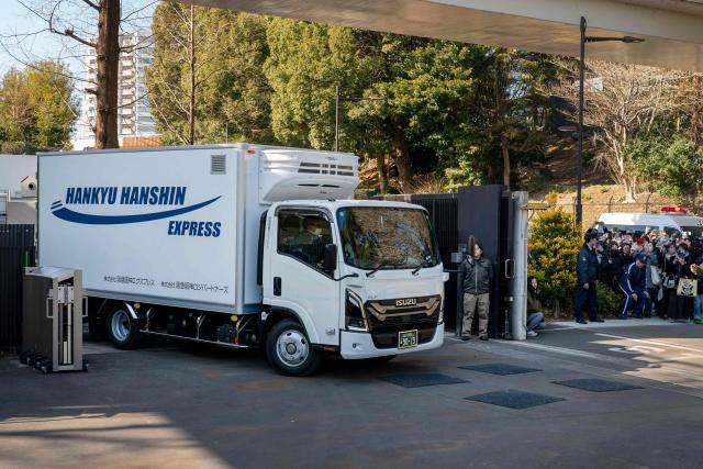 A truck believed to be carrying the twin pandas departs from Ueno Zoo in Tokyo on January 27, 2026, heading towards their return to China. (Photo by Kazuhiro NOGI / AFP)