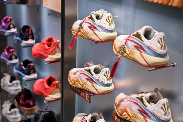Anta shoes are seen in an Anta store in the Huangpu district of Shanghai on January 27, 2026. Chinese athletic goods giant Anta Sports will buy a controlling stake in historic German sportswear brand Puma for 1.79 billion USD, a stock exchange filing showed, as it expands its international presence. (Photo by Hector RETAMAL / AFP)