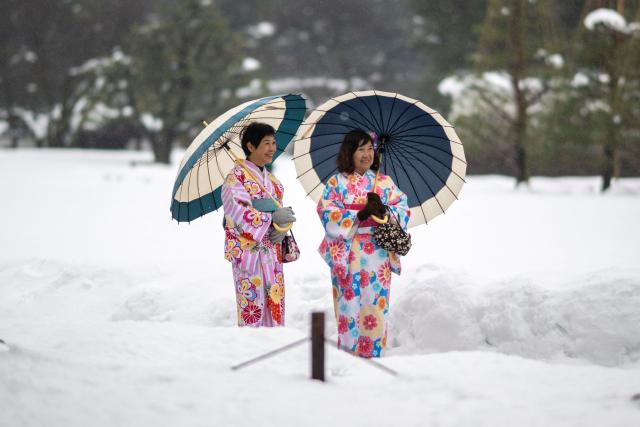 Tourists in traditional outfits visit the snow-covered Kanazawa Castle in Kanazawa, Ishikawa Prefecture on January 27, 2026. (Photo by Philip FONG / AFP)