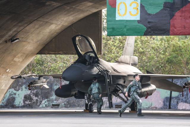 Pilots scramble to their Taiwanese air force F-16V fighter aircraft during a military exercise at Chiayi Air Base in Chiayi on January 27, 2026. (Photo by I-Hwa Cheng / AFP)