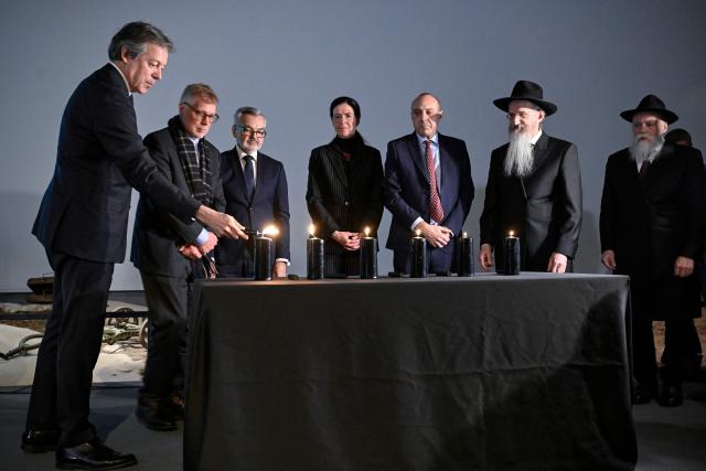 Participants, including British Ambassador to Russia Nigel Casey, Polish Ambassador to Russia Krzysztof Krajewski, Anke Holstein, adviser at the German Embassy in Russia, Israeli ambassador to Russia Oded Joseph and Chief Rabbi of Russia Berel Lazar, light candles during a ceremony marking International Holocaust Remembrance Day at the Jewish Museum and Tolerance Centre in Moscow on January 27, 2026. (Photo by Alexander NEMENOV / AFP)